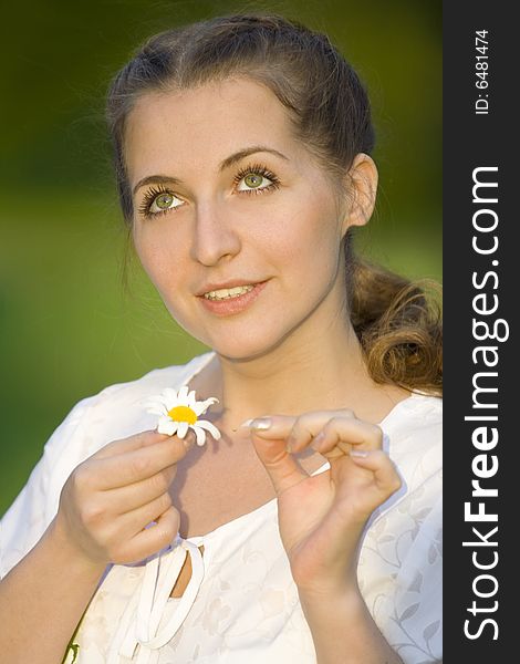 Beauty woman conjecture with chamomile. Beauty woman conjecture with chamomile