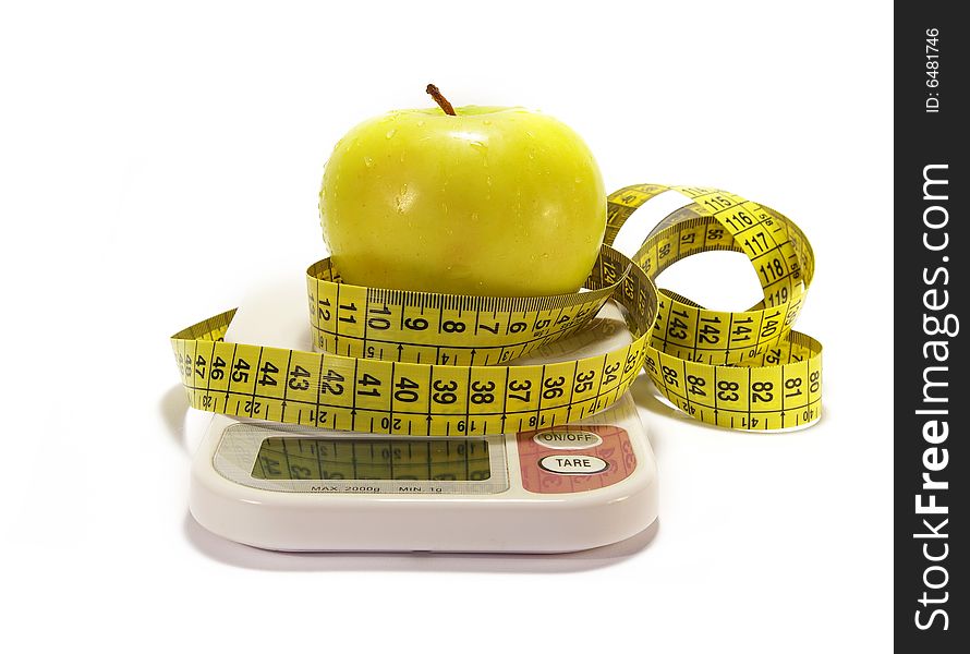 Green apple, scale and tape measure isolated. Green apple, scale and tape measure isolated