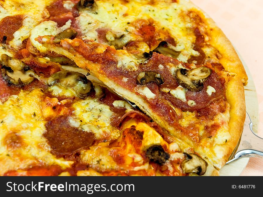 A pizza with cheese,salami - slices