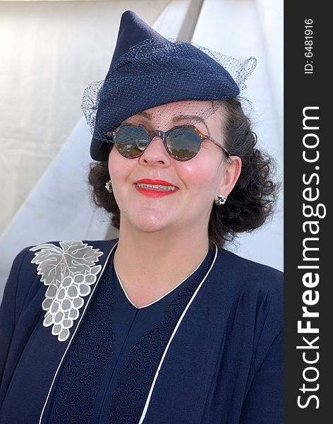 Retro girl in sunglasses at Goodwood Revival event, UK