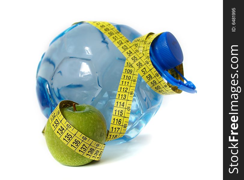 Plastic water bottle and green apple isolated