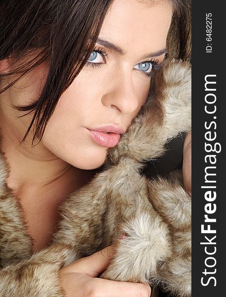 Portrait beautiful girl wearing brown fur. blue eyes. Portrait beautiful girl wearing brown fur. blue eyes