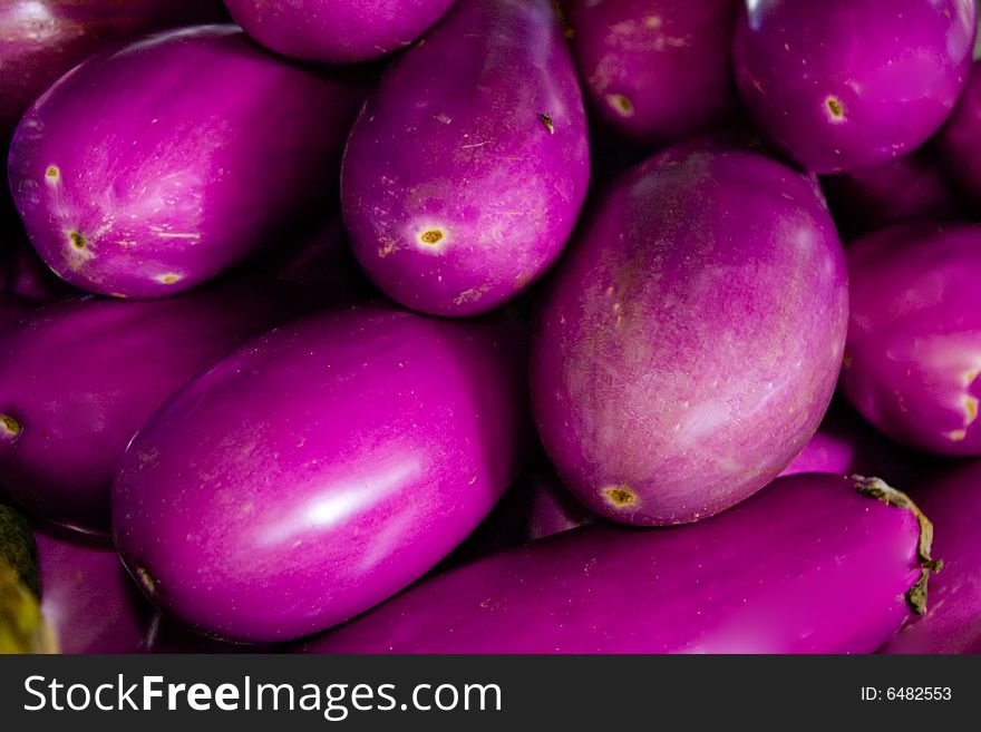 A group of eggplant at an outdoor market