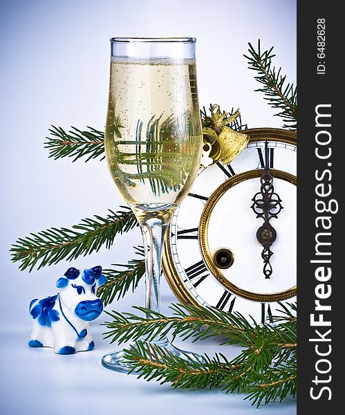 New Year's decoration with an antique clock and a firtree branch