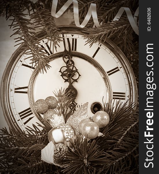 New Year's decoration with an antique clock and a firtree branch