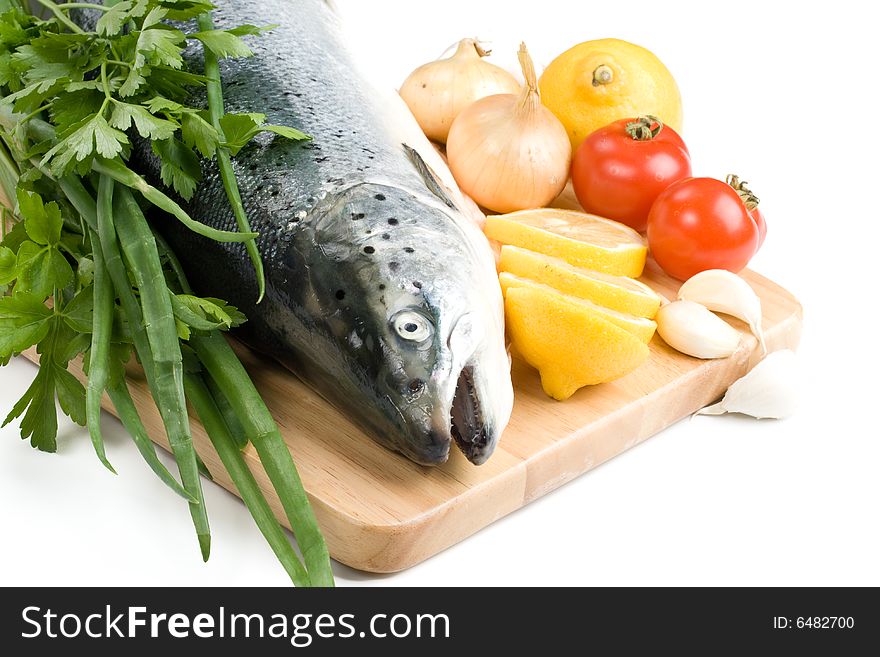 Fresh raw salmon with vegetables on a white background. Fresh raw salmon with vegetables on a white background