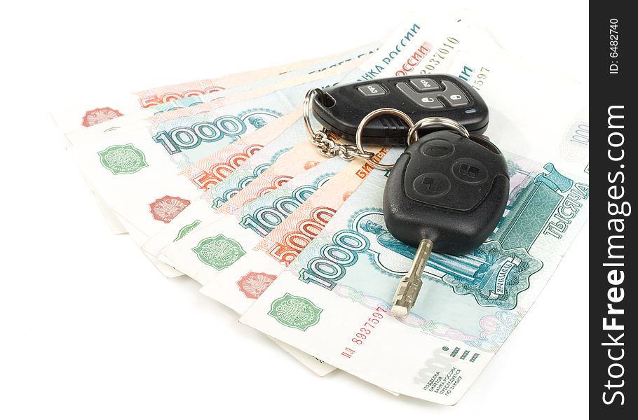 Car keys and money on a white background