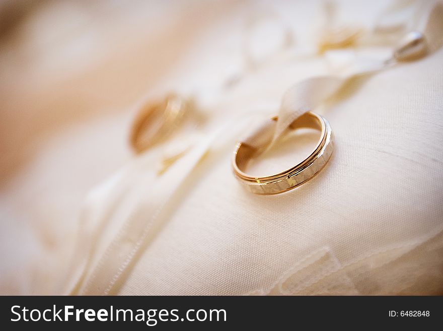 Gold wedding rings on the bed. Gold wedding rings on the bed