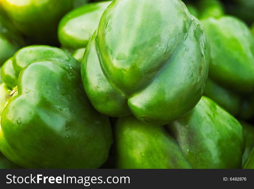 A closeup of a basket of green peppers. A closeup of a basket of green peppers