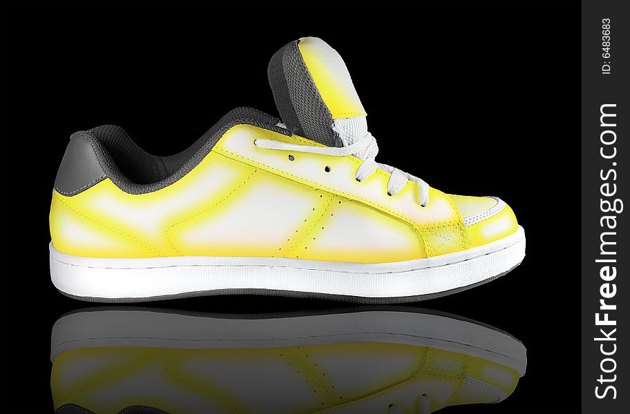 Yellow-white sneaker on a black background