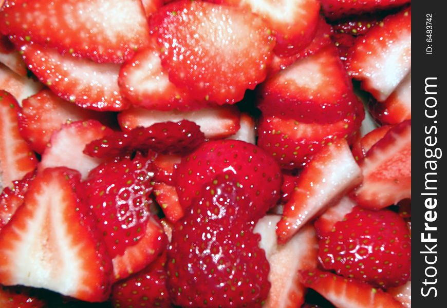 A bowl full of sliced strawberries