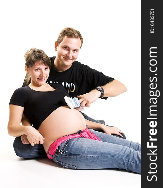 Young man and his pregnant wife isolated against white background