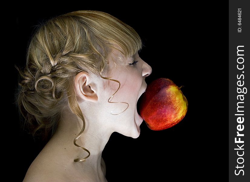 Girl,eating apple over the black background. Girl,eating apple over the black background