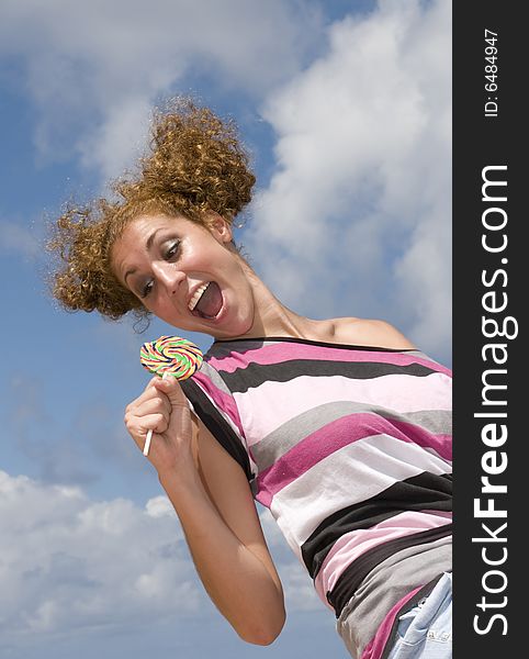 Fun Blonde Girl With Lollipop In Clouds