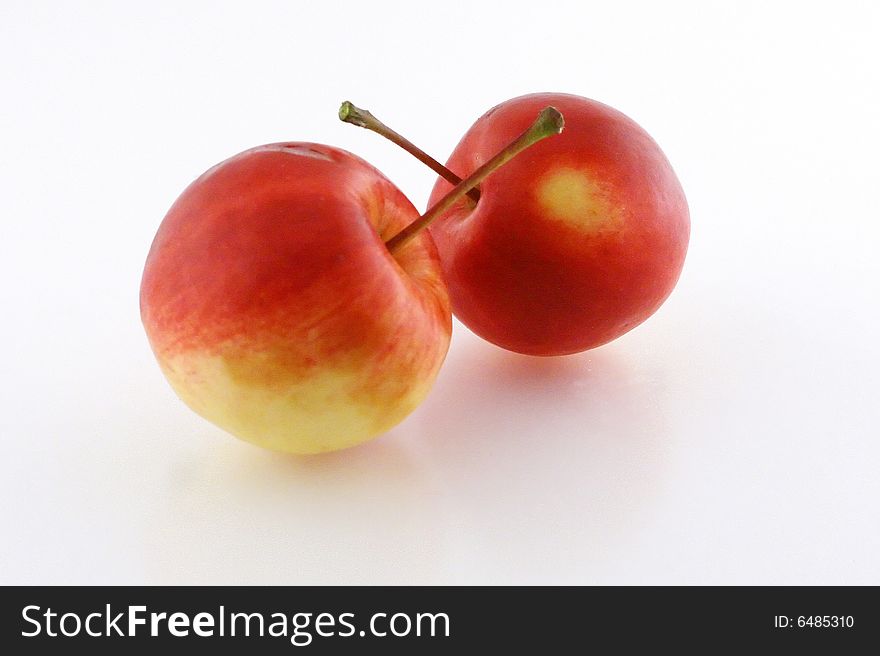 Two small red apples on white background