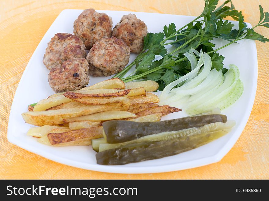 Cutlets nervozi with garnish (Bulgarian cuisine)