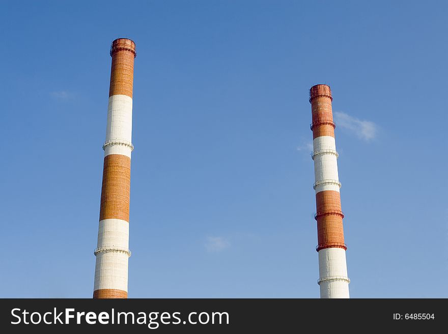 Two Red and white pipes on blue sky