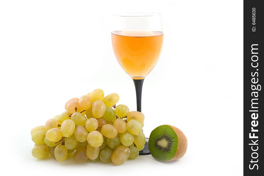 Light wine and grapes with a green fruit on white background