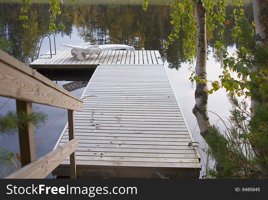 Lake, deckchair on the pier. Lake, deckchair on the pier