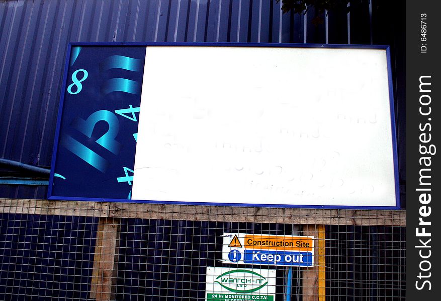 A blank small billboard in urban surroundings