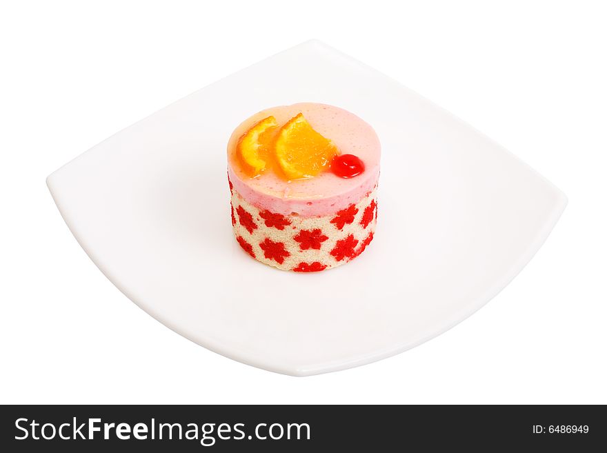 Cake with a cherry and an orange on a white plate