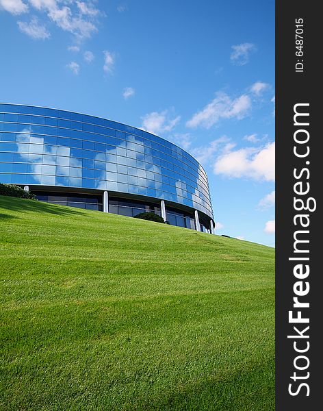 Round Hotel with Mirror windows atop grass. Round Hotel with Mirror windows atop grass