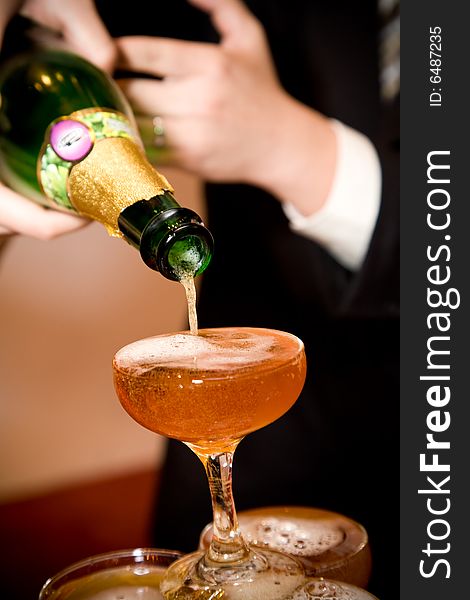 Groom pouring champagne on their wedding ceremony