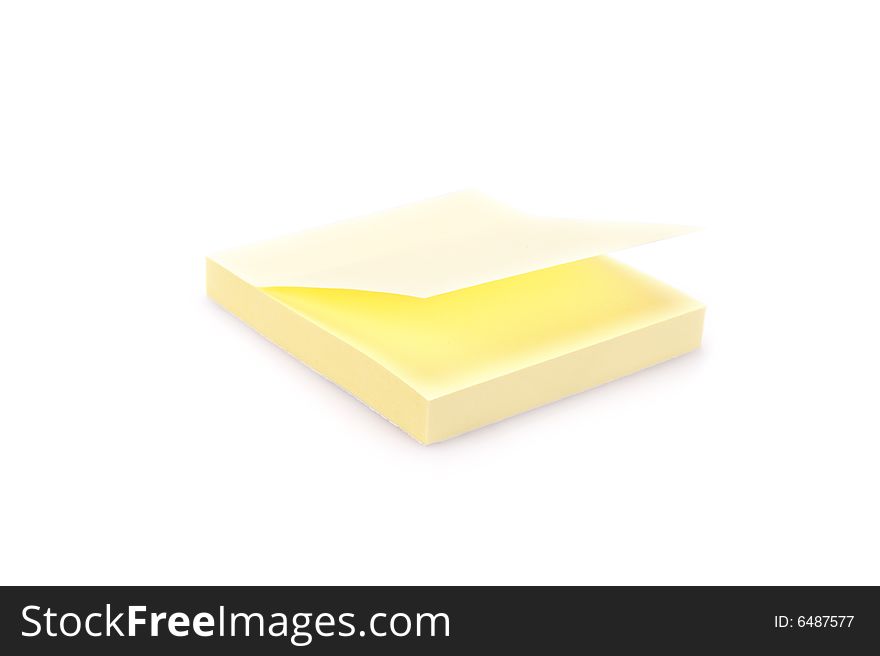 Closeup of a pad of yellow sticky notes. Isolated on white.
