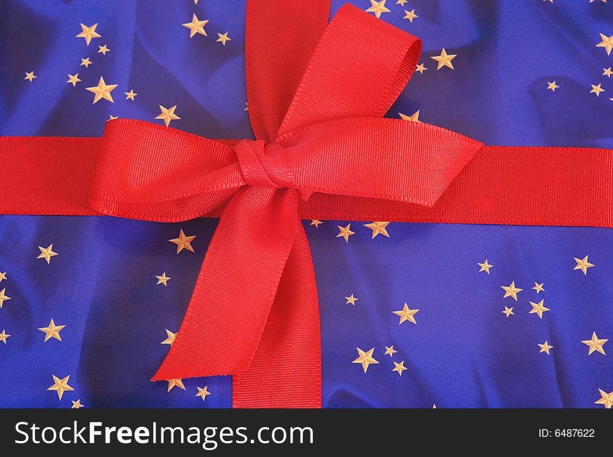 Red ribbon on blue background with golden stars. Red ribbon on blue background with golden stars.