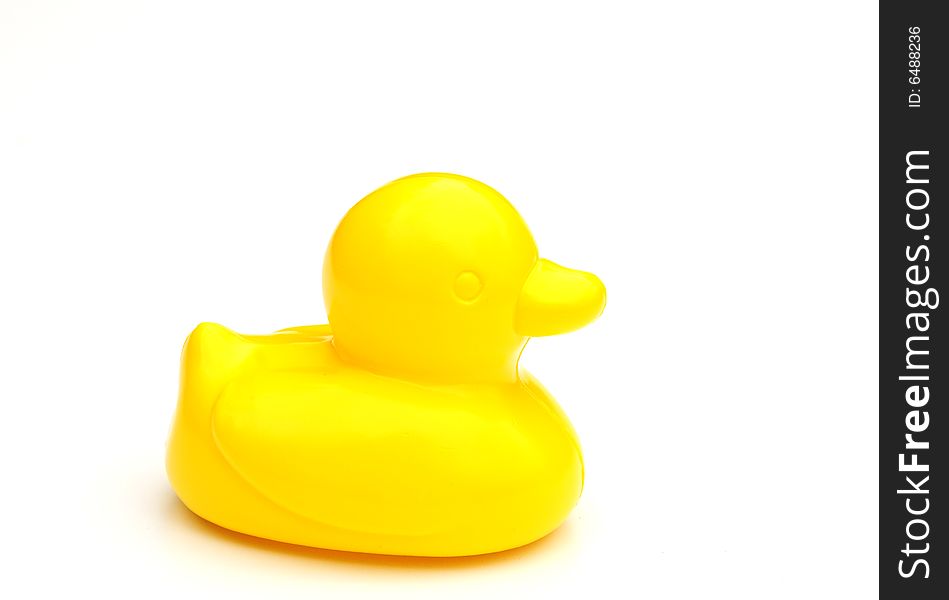 A shot of a yellow bath time duck. A shot of a yellow bath time duck