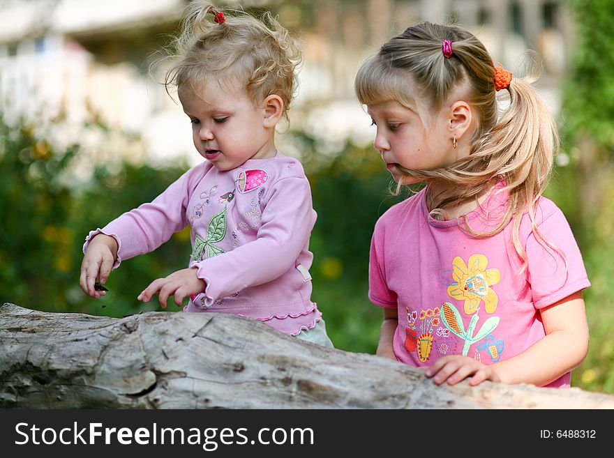 An image of two children playing outdoor. An image of two children playing outdoor