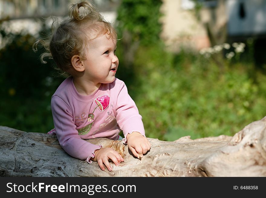 An image of  baby girl playing outdoor