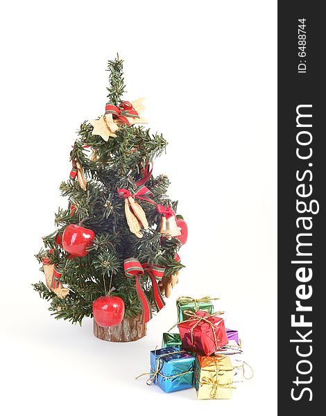 Christmas tree and color gift boxes on white background.