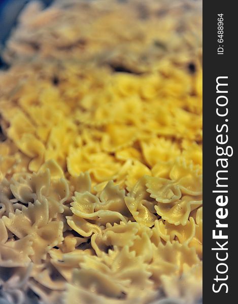 Close up details of freshly cooked yellow pasta shells. Close up details of freshly cooked yellow pasta shells.