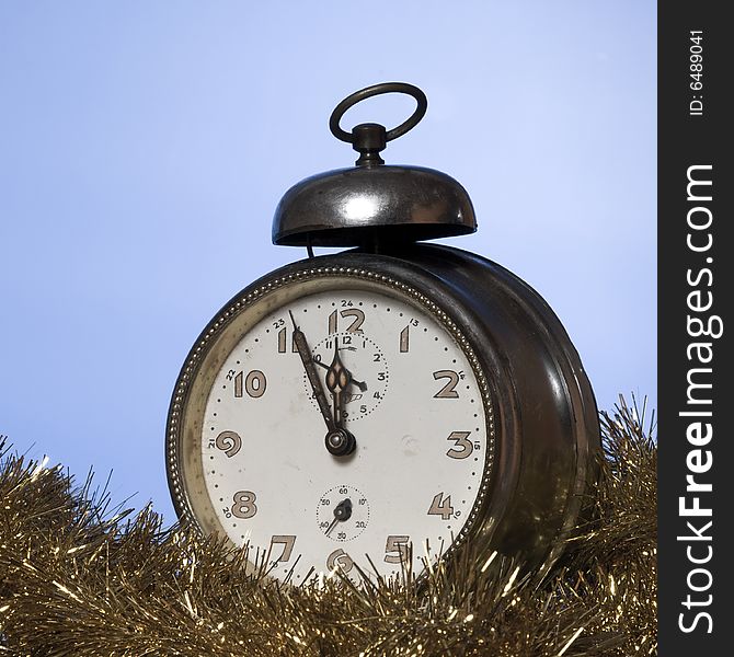 Old Alarm Clock showing few minutes to twelve