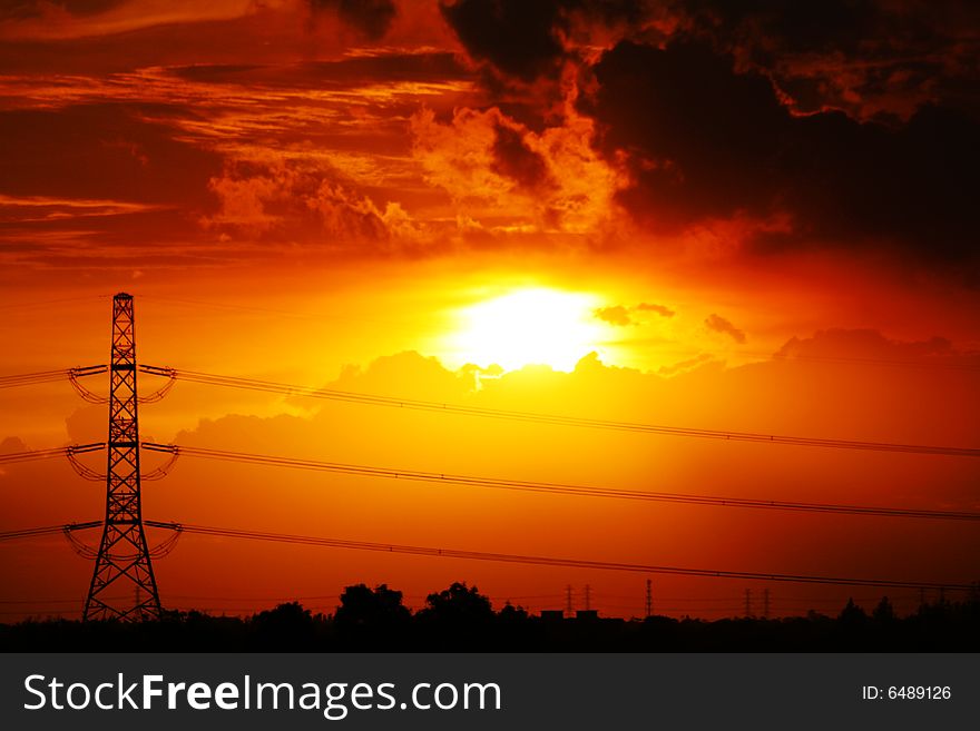 Sunset at high voltage tower and orange sky. Sunset at high voltage tower and orange sky