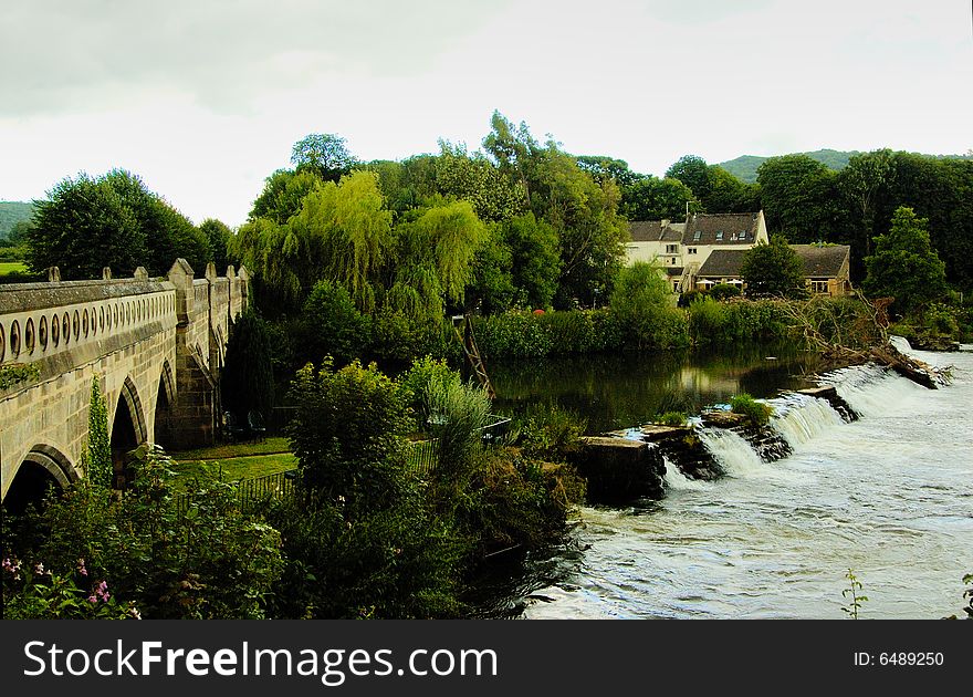 Stone bridge across the river under the willow. Stone bridge across the river under the willow