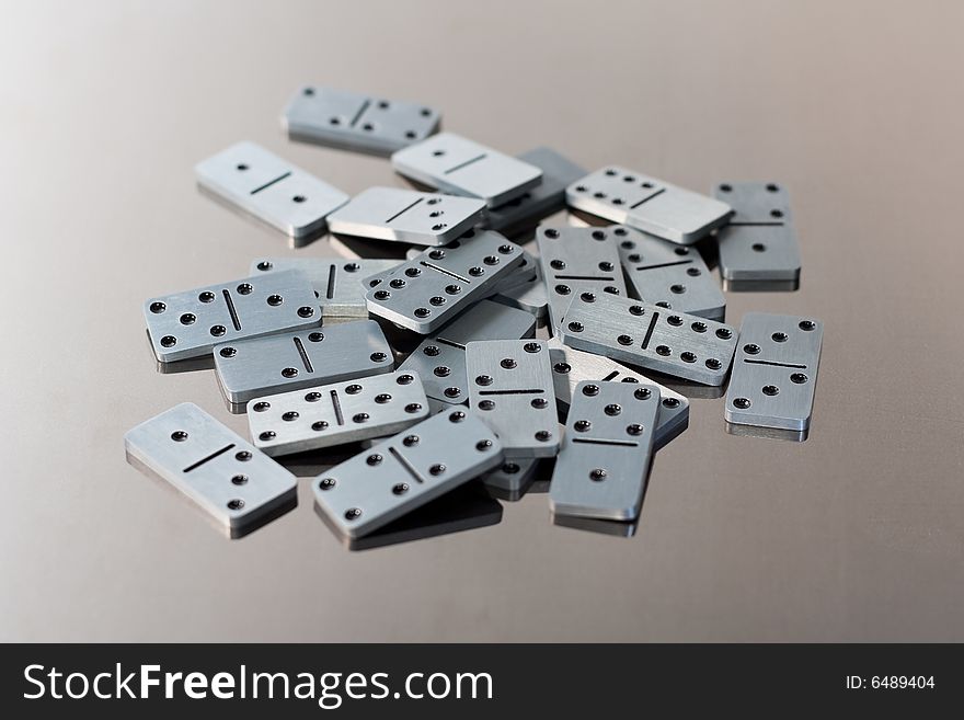 Steel dominoes on a polished surface