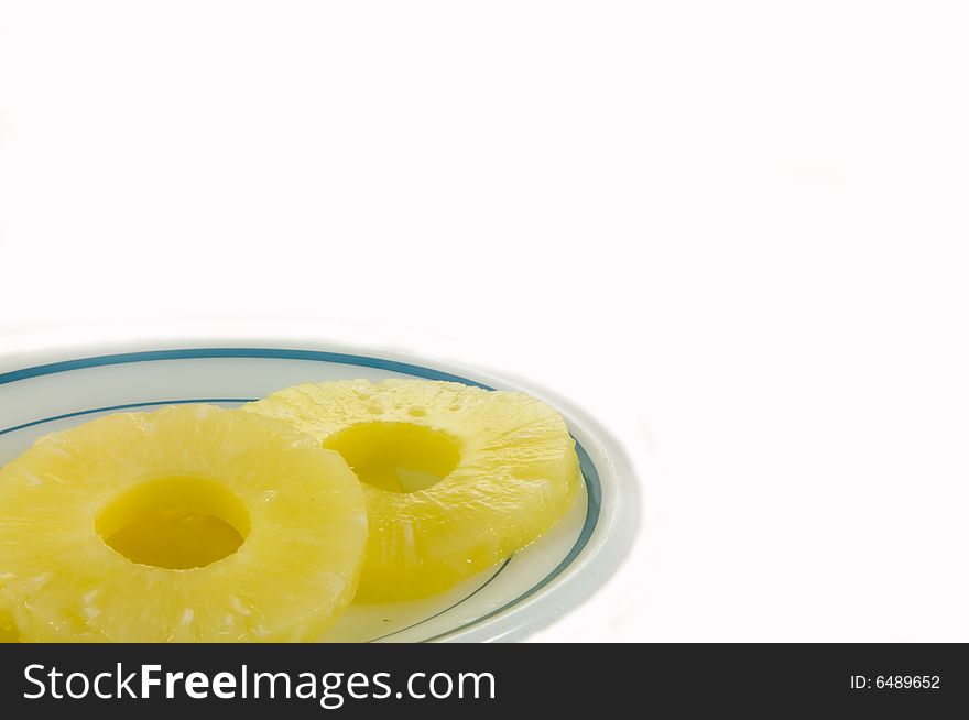 Two slices of sweet dried pineapple on white background