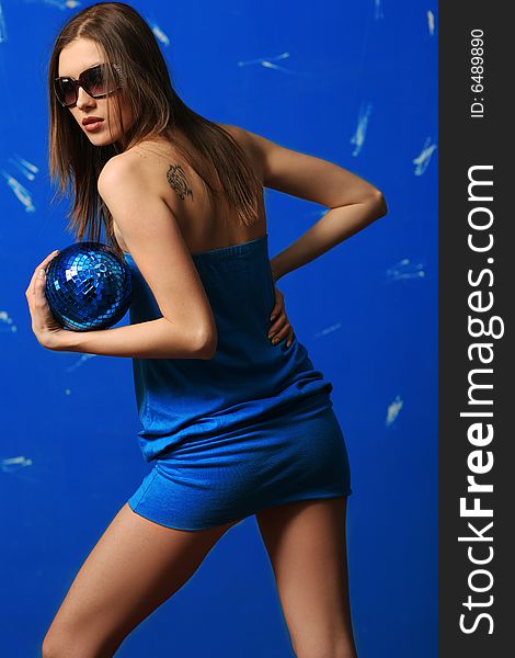 Woman with sphere. blue background