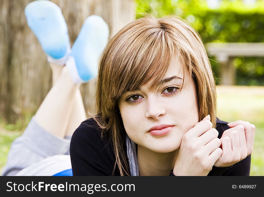 Beautiful young woman resting in the park. Beautiful young woman resting in the park.