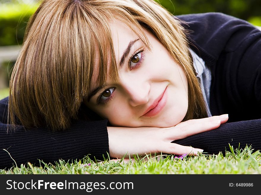 Smiling beauty on grass