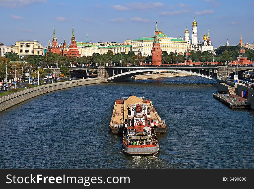 Kind from the bridge on the river with floating on it a vessel, on a background, the Moscow Kremlin. Kind from the bridge on the river with floating on it a vessel, on a background, the Moscow Kremlin