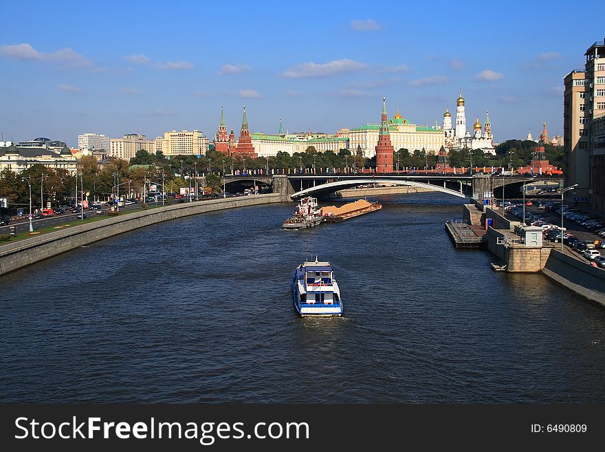 Kind from the bridge on the river with floating on it a vessel, on a background, the Moscow Kremlin. Kind from the bridge on the river with floating on it a vessel, on a background, the Moscow Kremlin