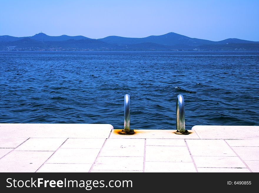 Blue sea and ladder at the beach. Blue sea and ladder at the beach