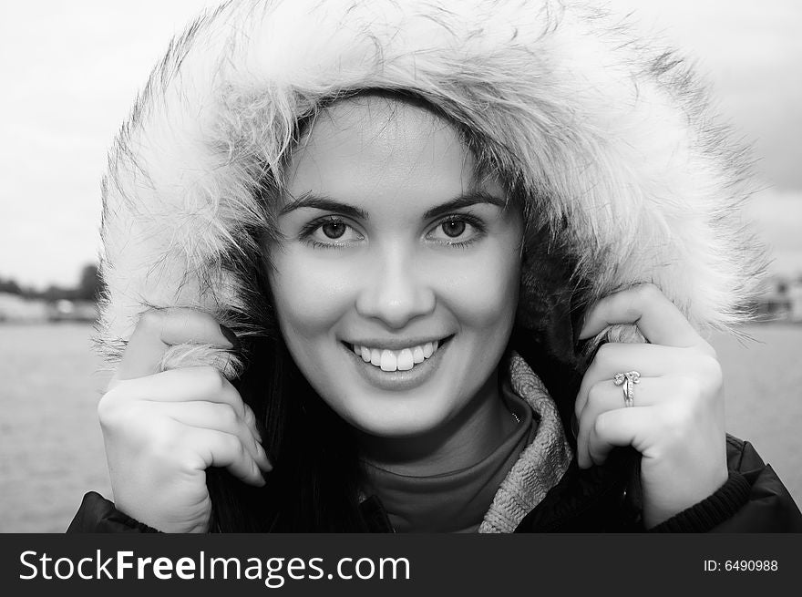 Beautiful, smiling young woman with a fur hood(black and white). Beautiful, smiling young woman with a fur hood(black and white)