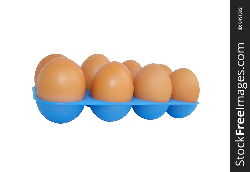 Eggs on a white background in a dark blue tray