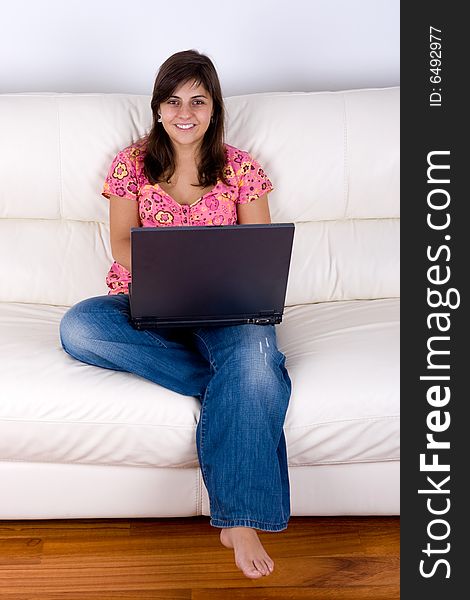 Beautiful Young Woman With Laptop On Sofa