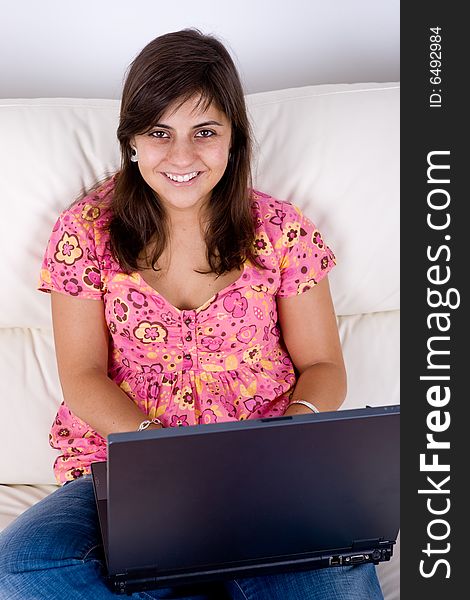 Beautiful Young Woman With Laptop On Sofa