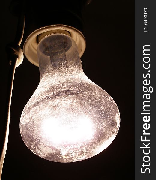 Be single luminous bulb on a dark background. Be single luminous bulb on a dark background